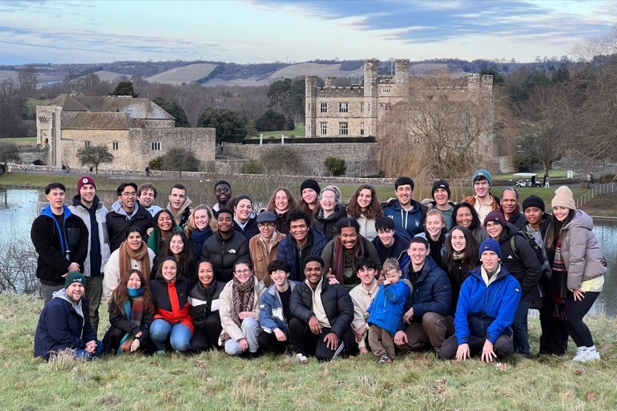 A large group of young people outside a castle